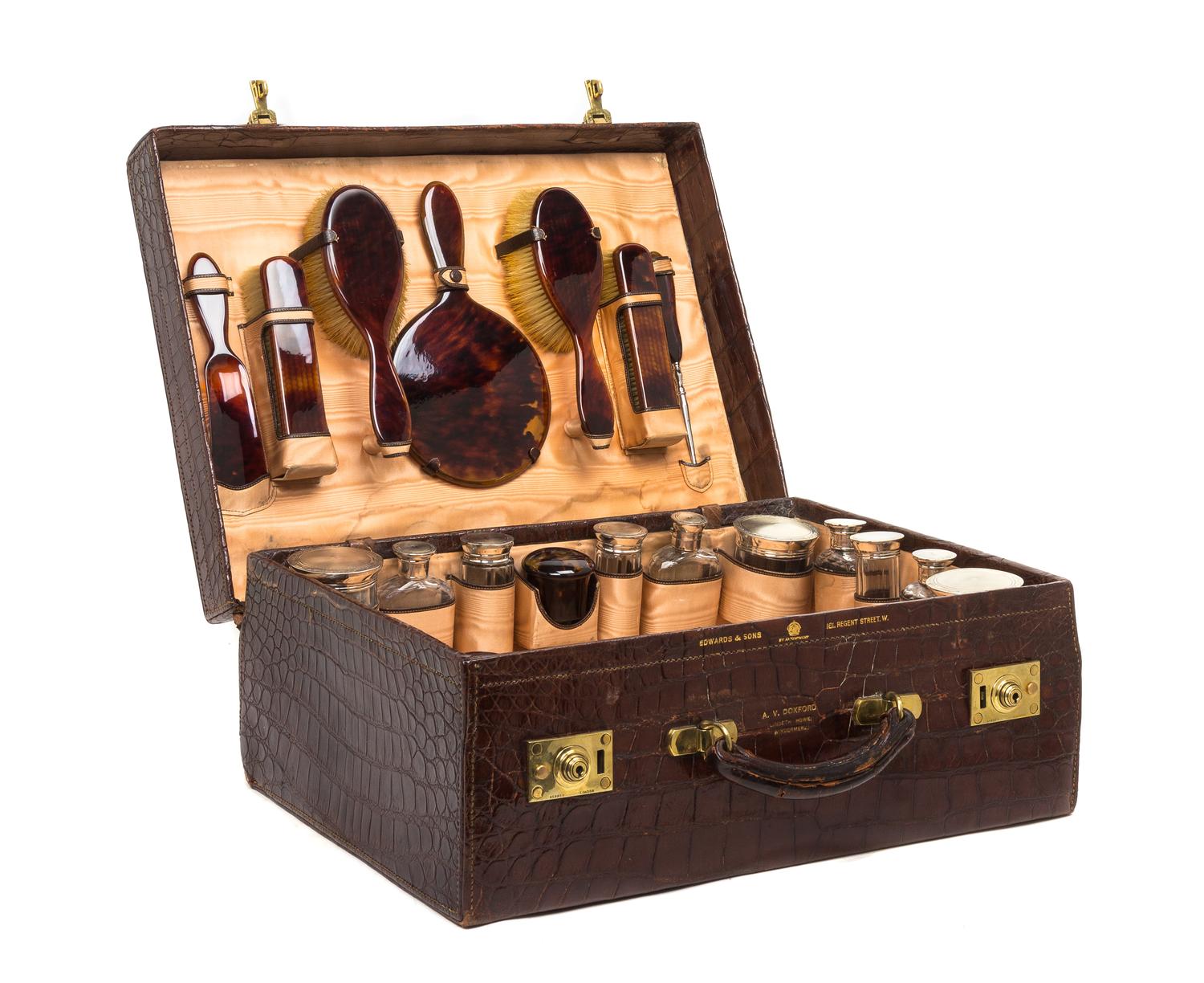 An English Alligator Dressing Case, ASPREY, RETAILED BY EDWARDS & SONS, LONDON, Height of case 7 3/4 x width 20 1/2 x depth 15 1/2 inch — ASPREY, RETAILED BY EDWARDS & SONS, LONDON,