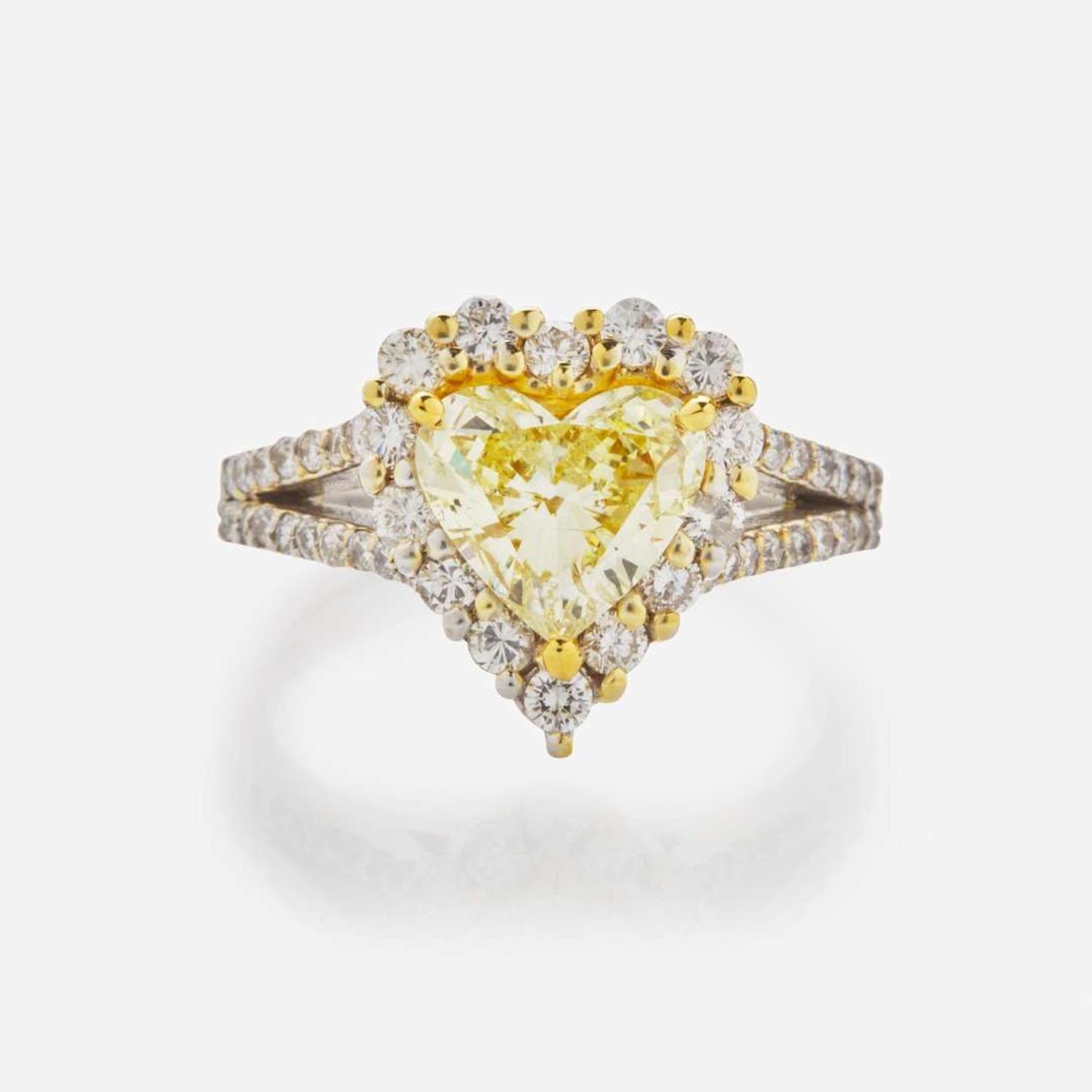 A Heart-Shape Colored Diamond, Diamond, and 18K Gold Ring 1.68 Carat Natural Fancy Yellow Heart-Shaped Diamond, GIA Certified