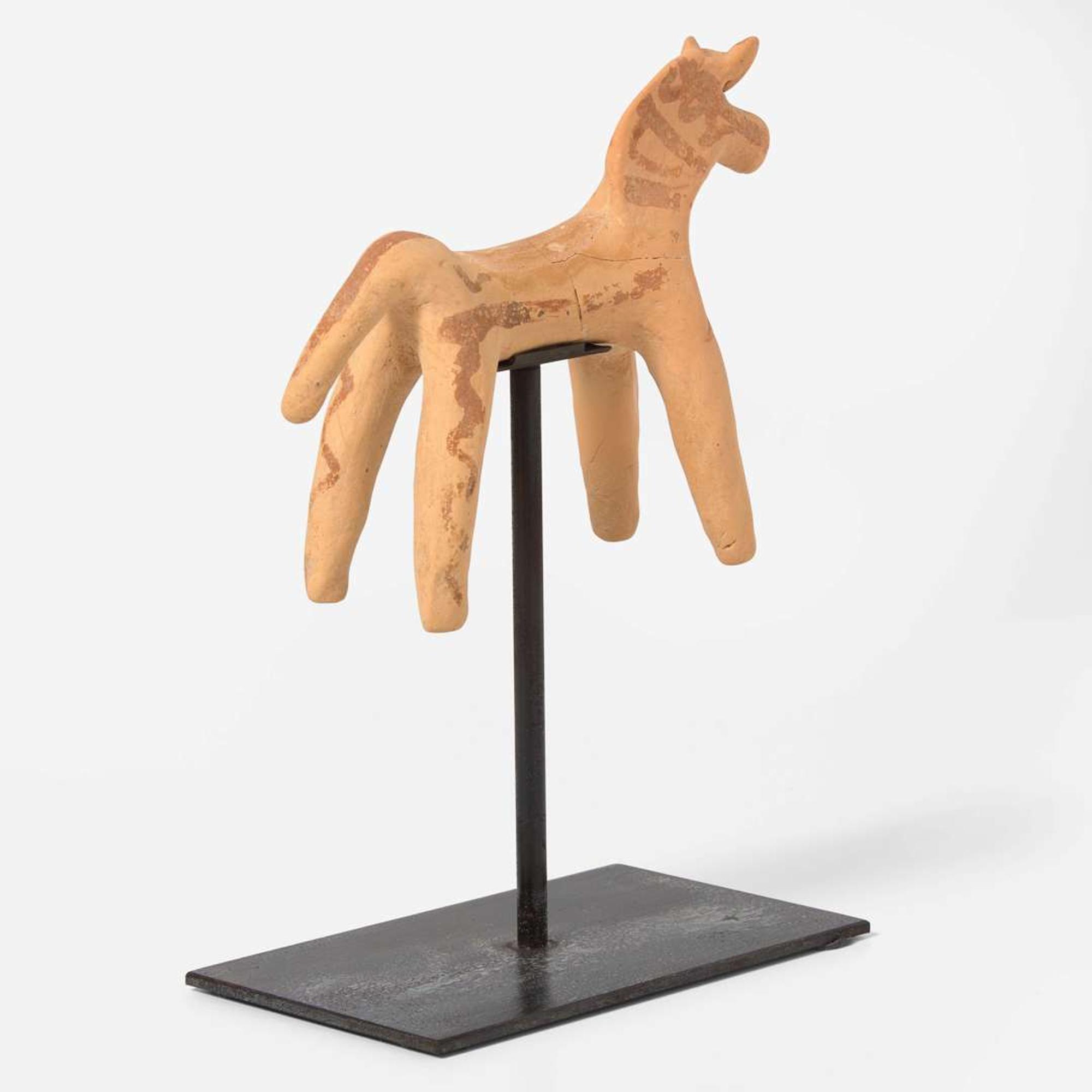 A Boeotian terracotta figure of a horse circa 6th century B.C.