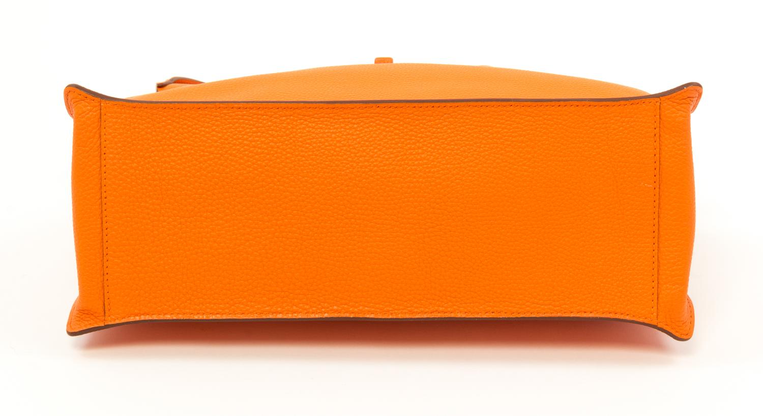 An Hermès Orange Togo Etribelt Handbag, 13.5" x 10.5" x 5"; Handle drop: 3.5".