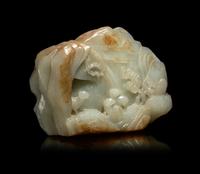 A Chinese Carved Russet and Pale Celadon Jade Boulder
