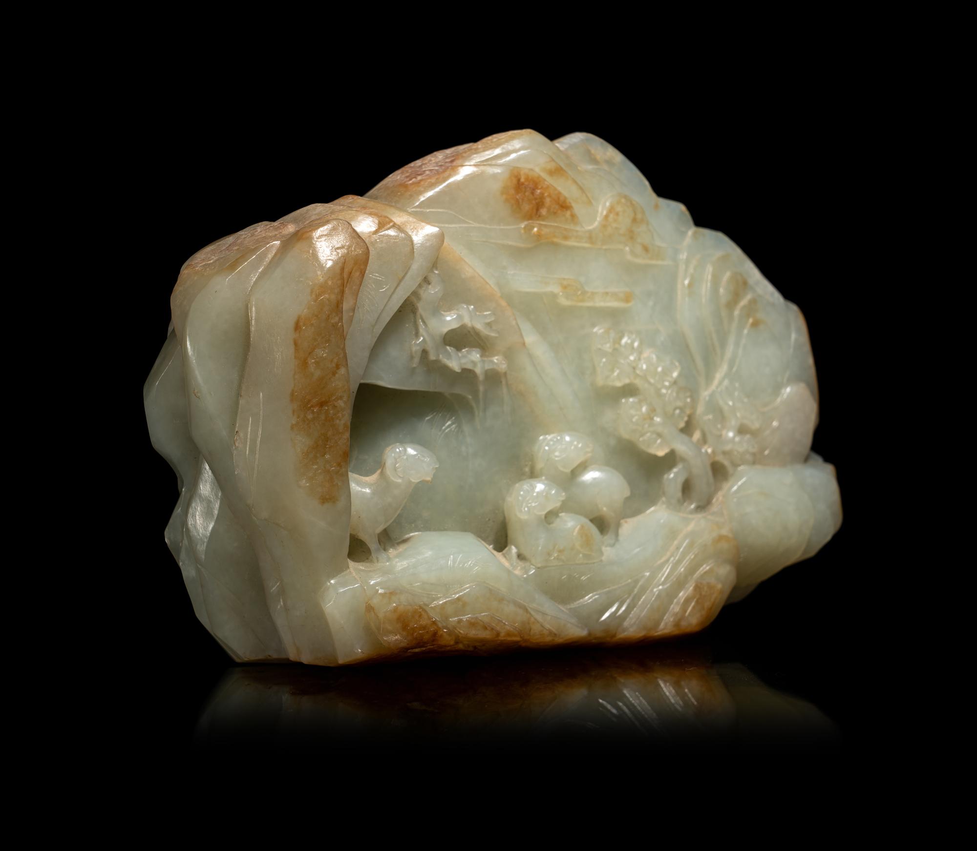 A Chinese Carved Russet and Pale Celadon Jade Boulder