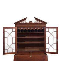 A Chippendale Carved Mahogany Desk-and-Bookcase