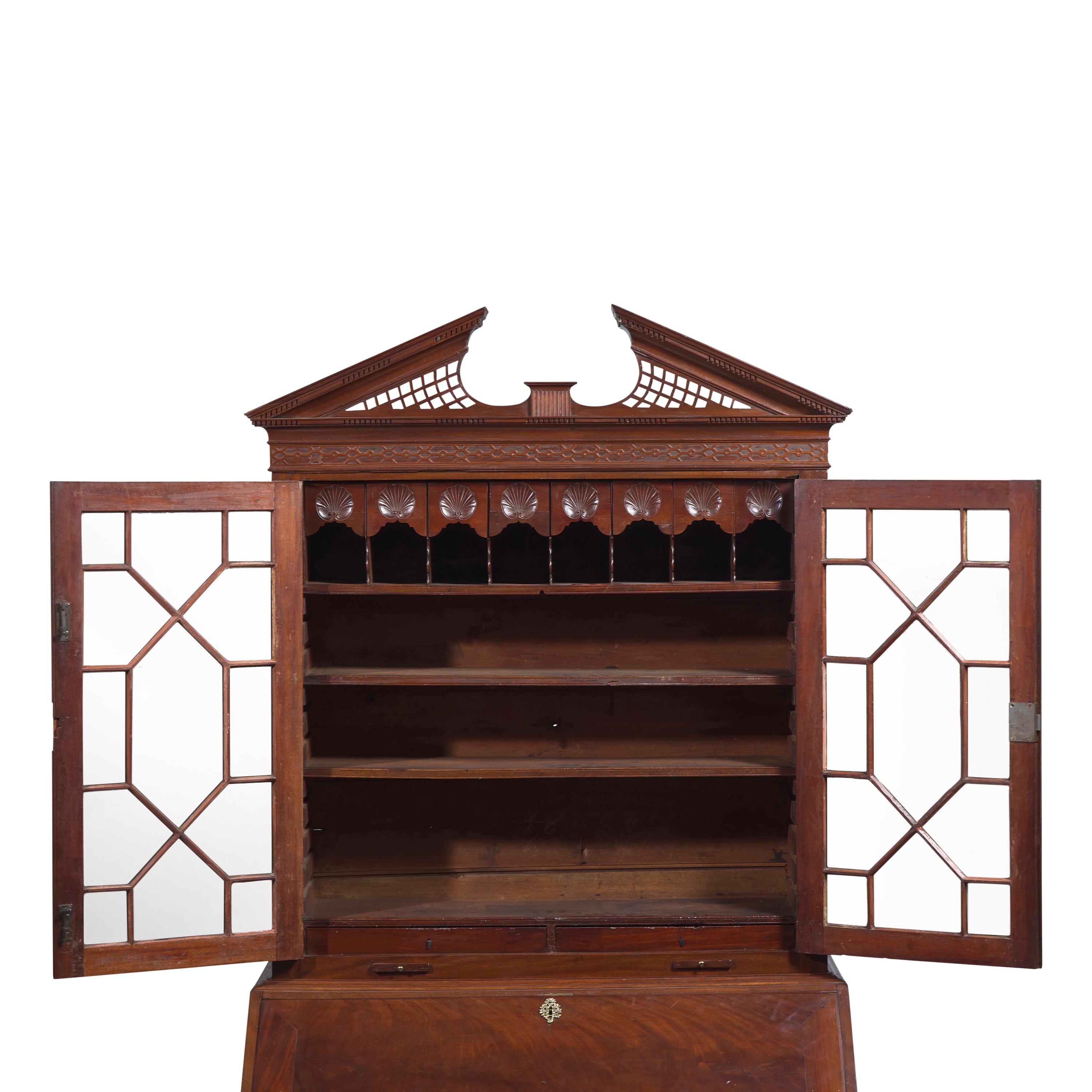 A Chippendale Carved Mahogany Desk-and-Bookcase