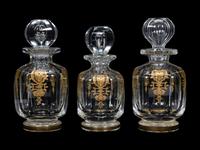A Set of Three Baccarat Glass Decanters with Gilt Decoration