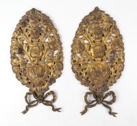 A Pair of Pressed Brass Wall Appliques Height 17 inches.