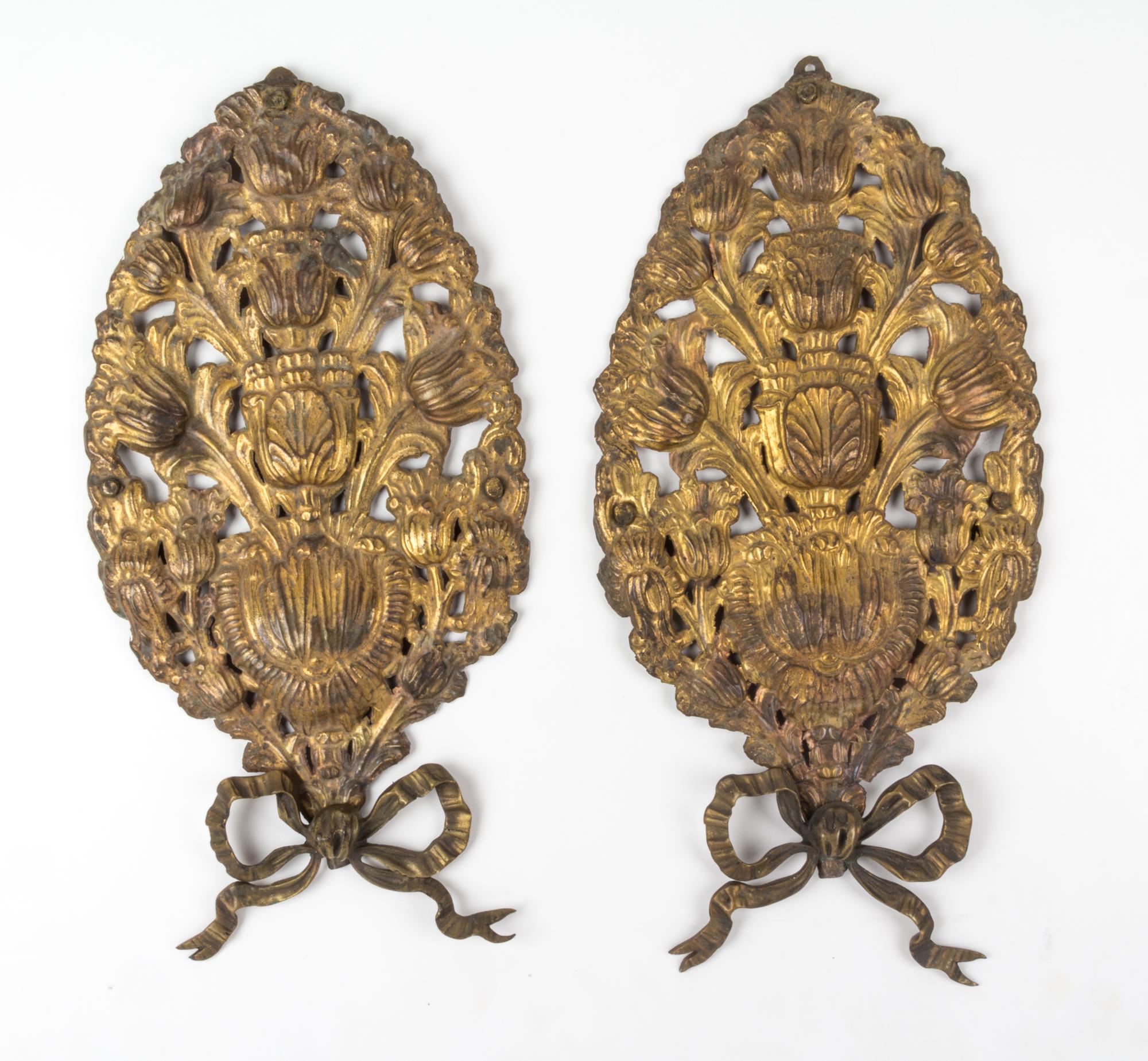 A Pair of Pressed Brass Wall Appliques Height 17 inches.