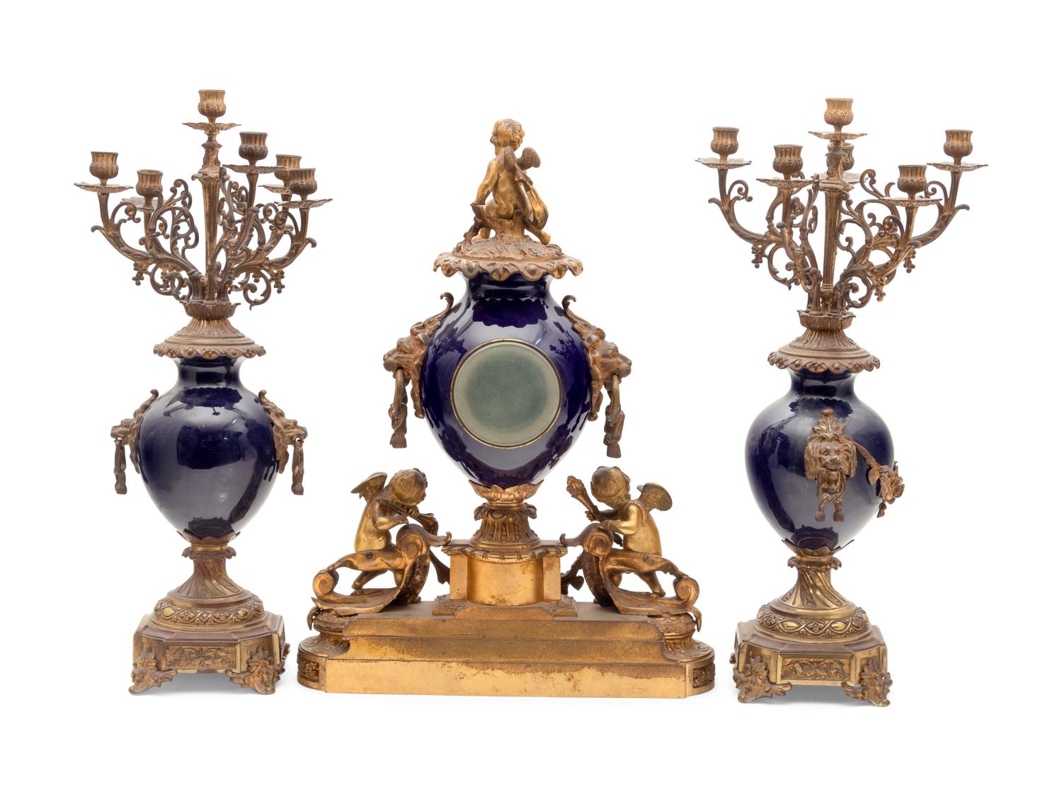 A French Gilt Bronze and Porcelain Clock Garniture