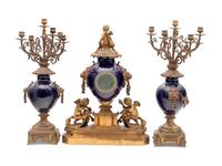 A French Gilt Bronze and Porcelain Clock Garniture