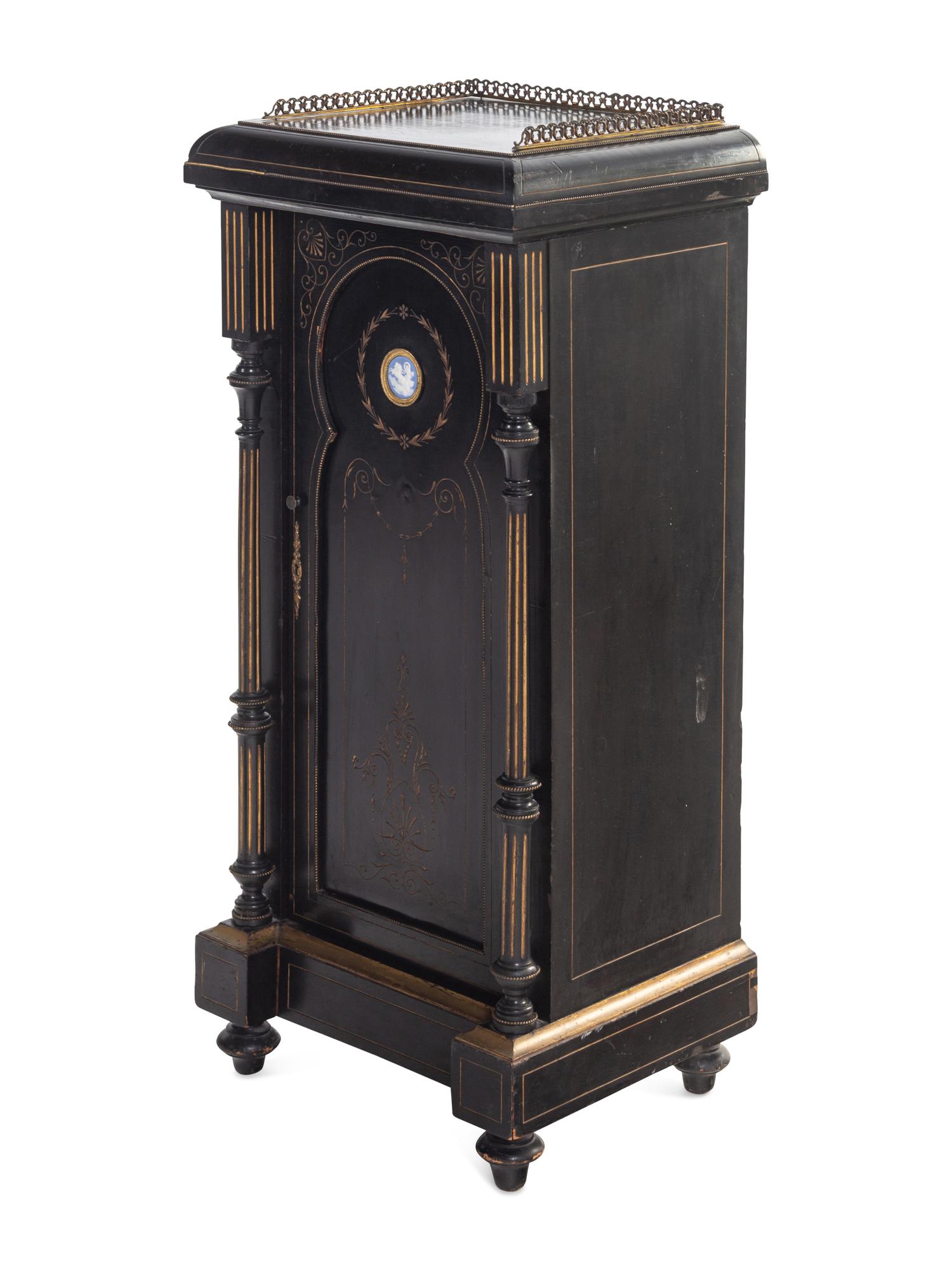 A Pair of English Aesthetic Jasperware Medallion-Mounted Ebonized and Parcel-Gilt Pedestal Cabinets