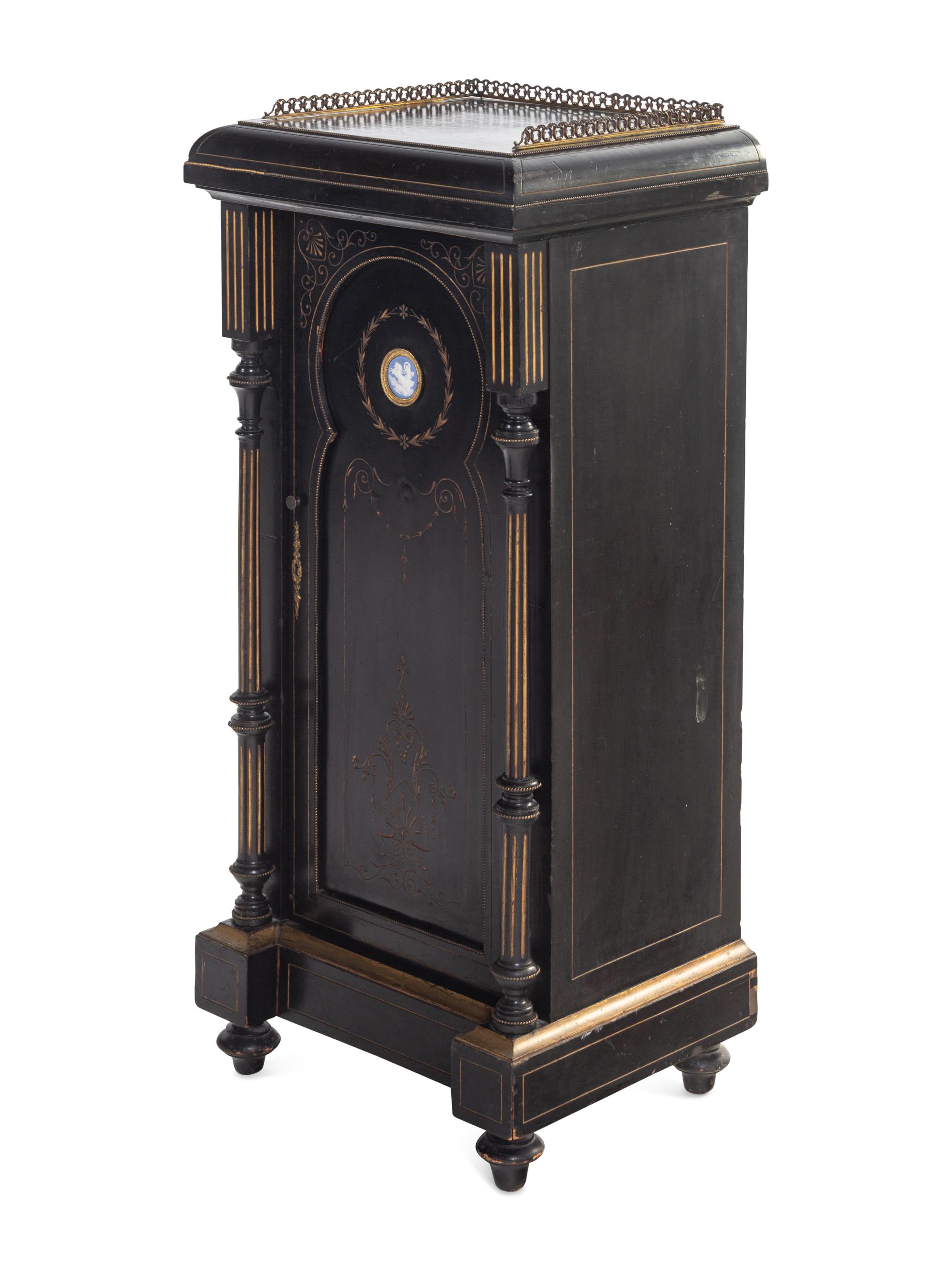 A Pair of English Aesthetic Jasperware Medallion-Mounted Ebonized and Parcel-Gilt Pedestal Cabinets