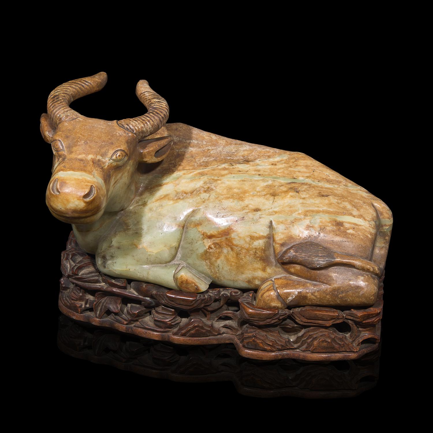 A Large Chinese Celadon and Beige Jade Buffalo, 18th/19th Century 清中期 青玉臥牛