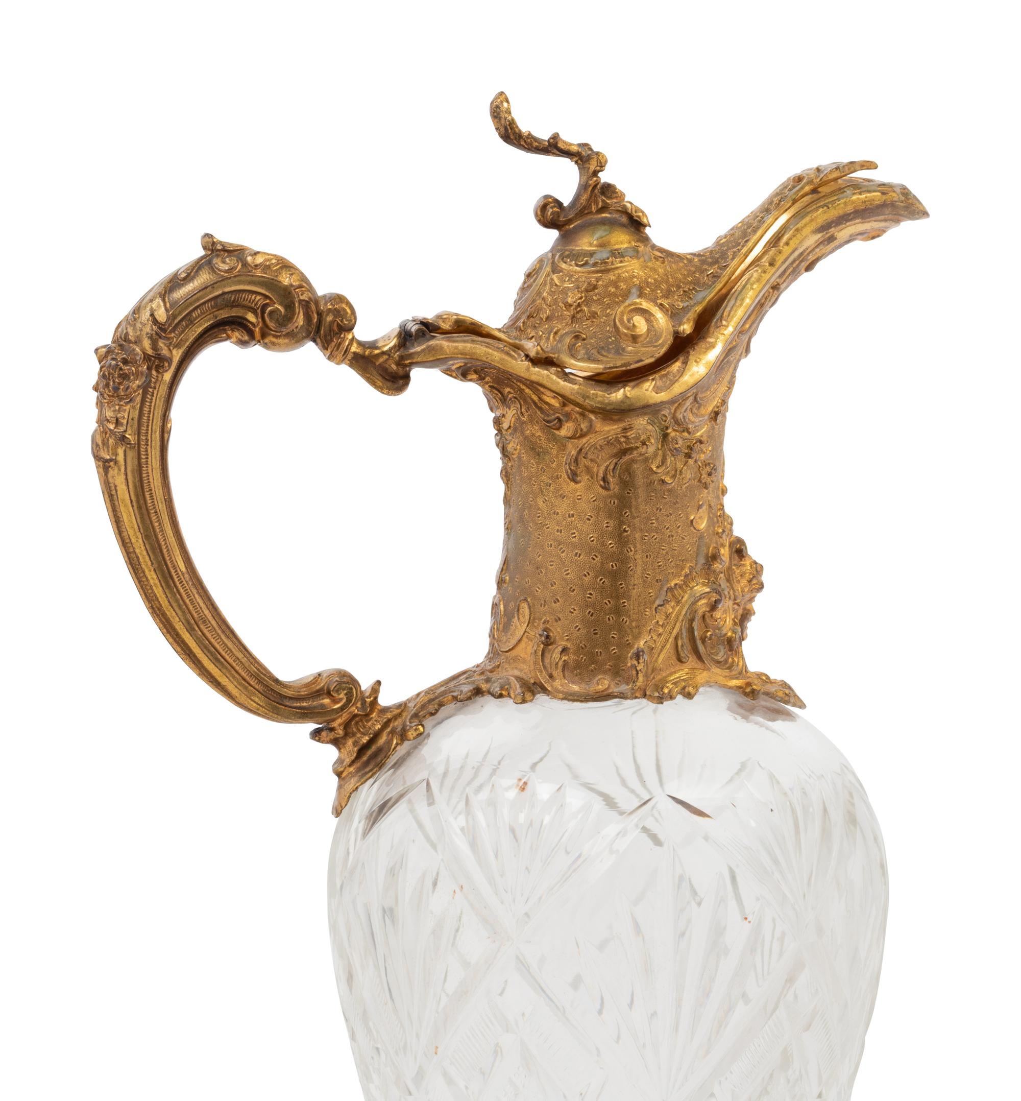 A Gilt Metal Mounted Cut Glass Claret Jug