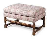 A Louis XIII Style Carved Armchair and Ottoman