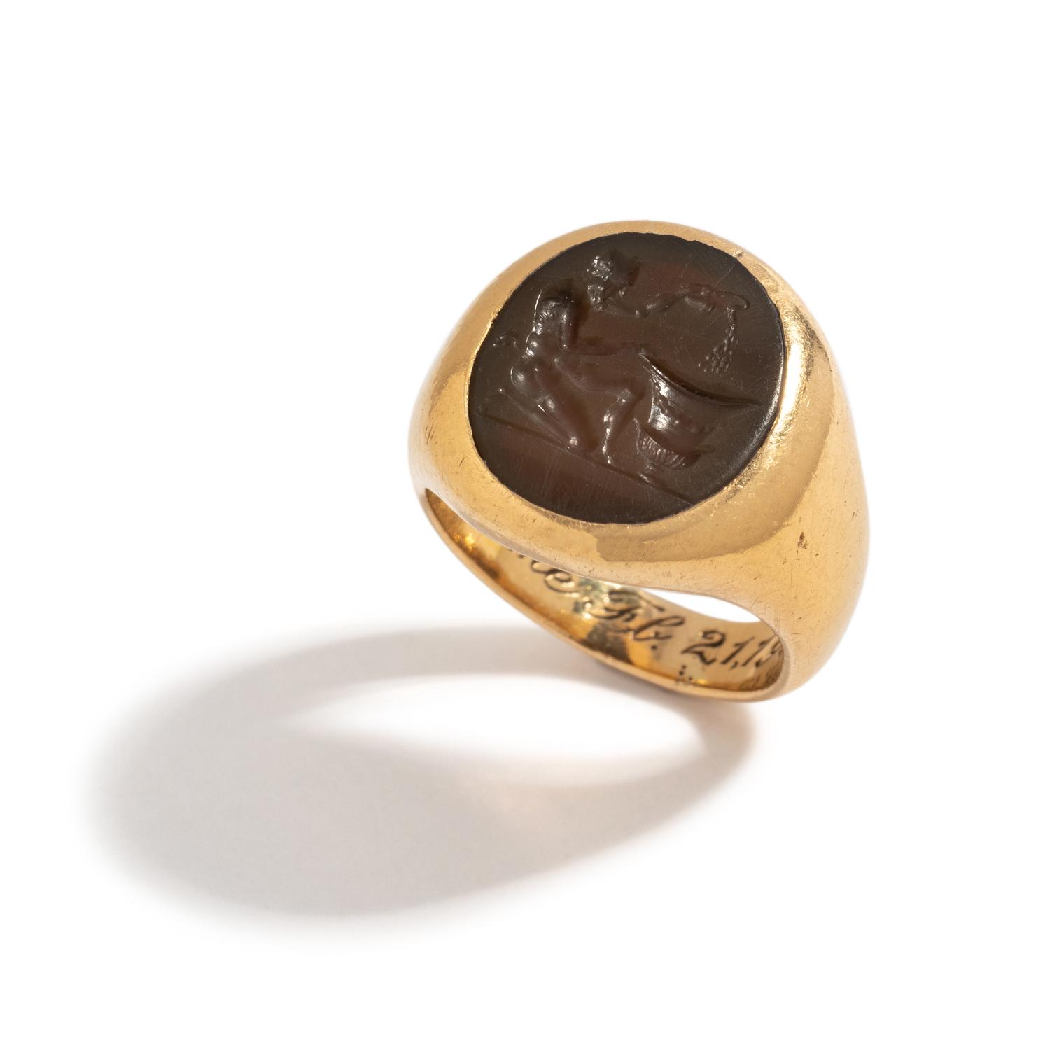 A Roman Carnelian Ring Stone with a Satyr Mixing Wine — Set in a gold ring