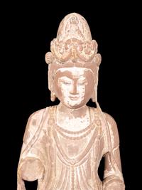 A Chinese Carved Sandstone Buddha with Remnants of Polychrome Decoration