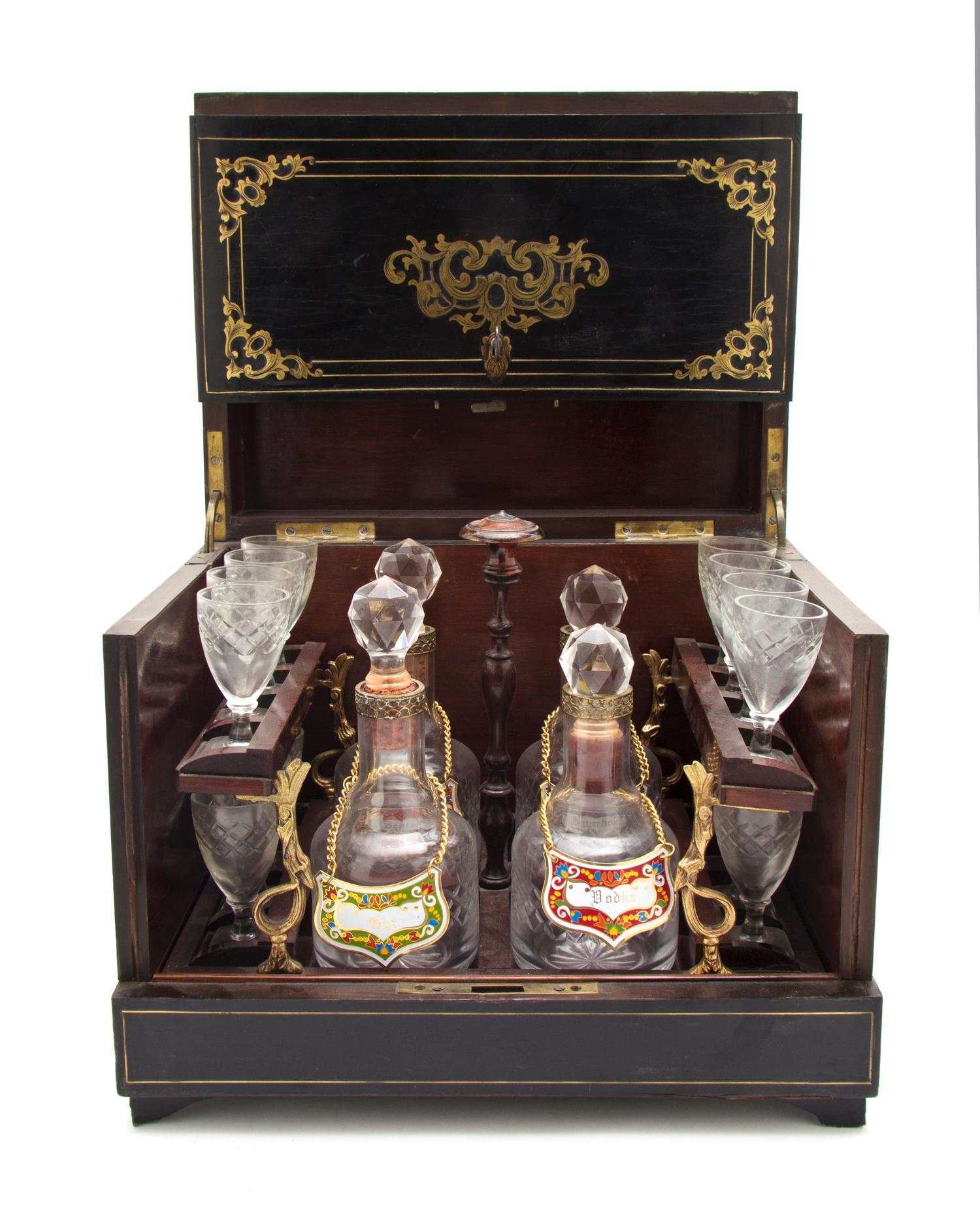 A Continental Ebonized and Brass Inlaid Cave a Liqueur, Height of case 10 3/8 x width 12 3/8 x depth 9 1/2 inches.