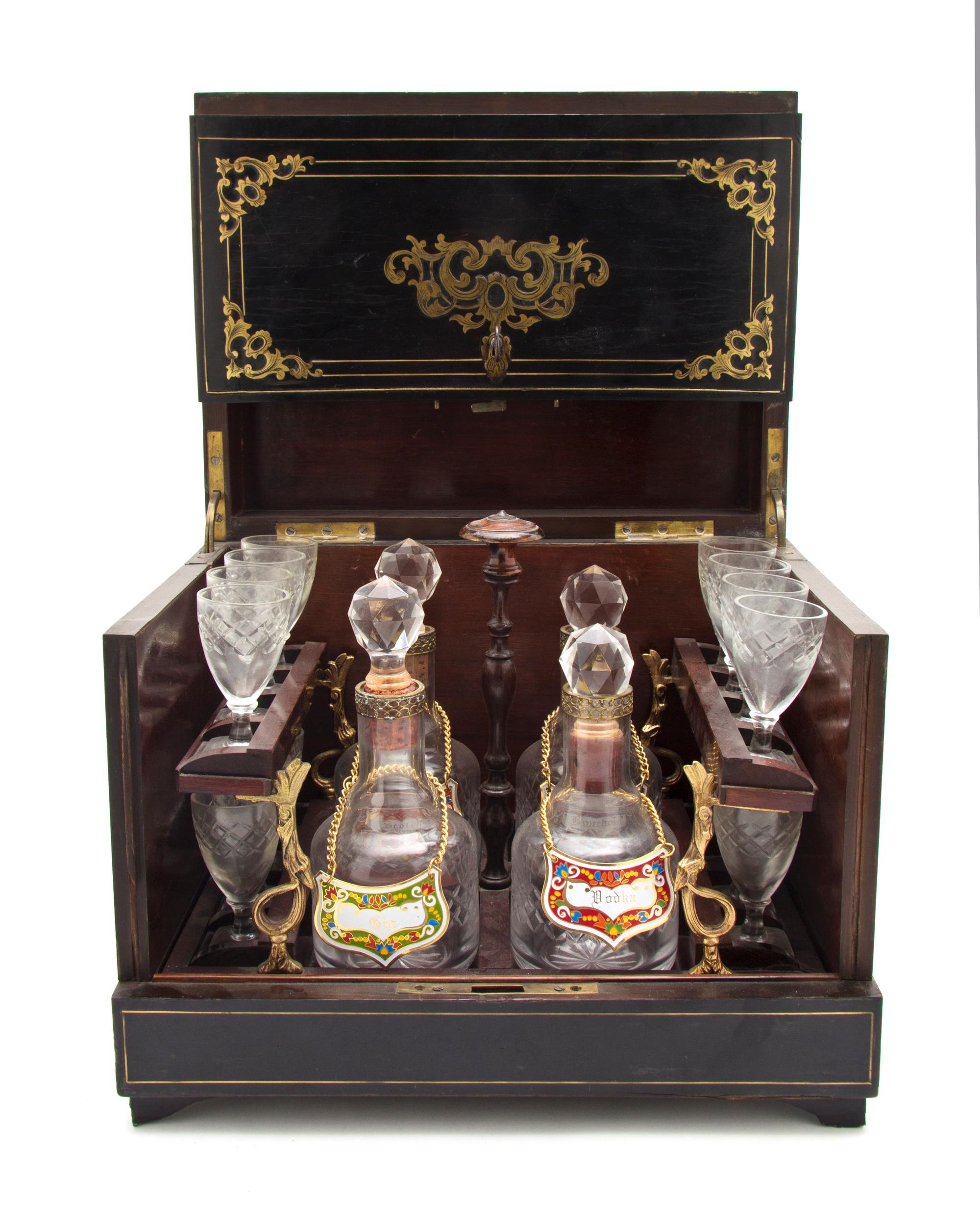 A Continental Ebonized and Brass Inlaid Cave a Liqueur, Height of case 10 3/8 x width 12 3/8 x depth 9 1/2 inches.