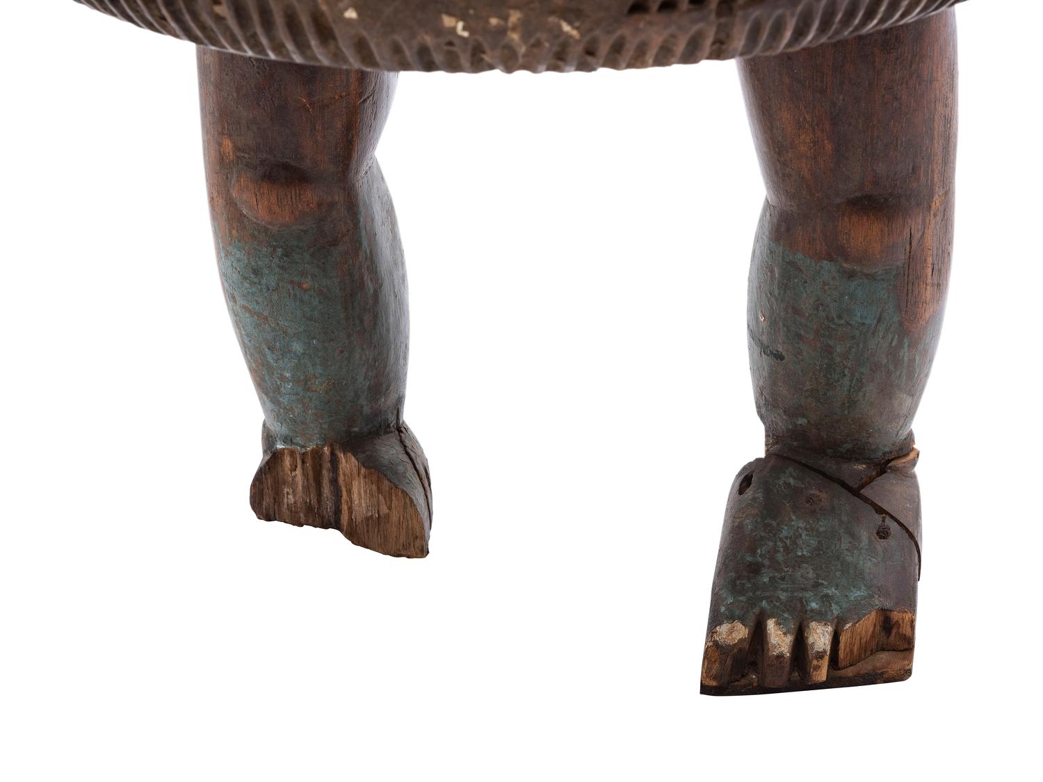 An Ashanti Carved and Gouged Painted Wood Breasted Drum