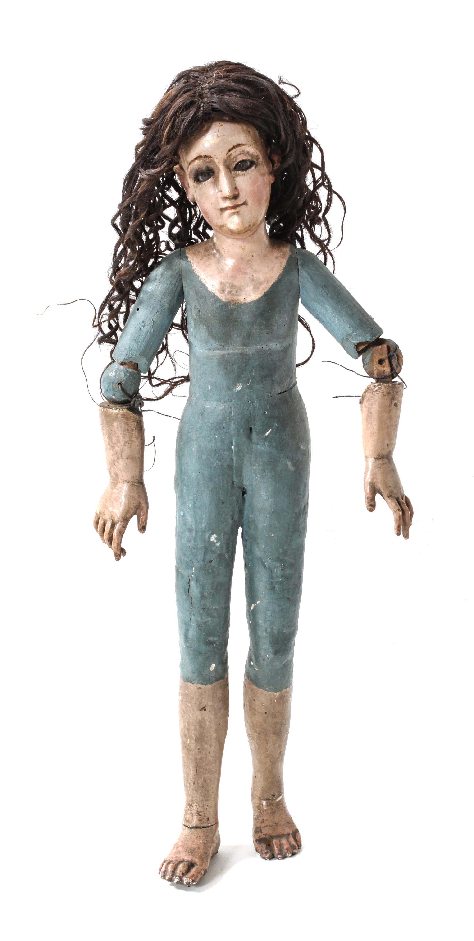 A Spanish Colonial Carved Polychrome Bulto of a Female Figure Length 23 1/2 inches. — LATE 19TH CENTURY