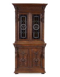 A Renaissance Revival Carved Oak and Leaded Glass Bookcase
