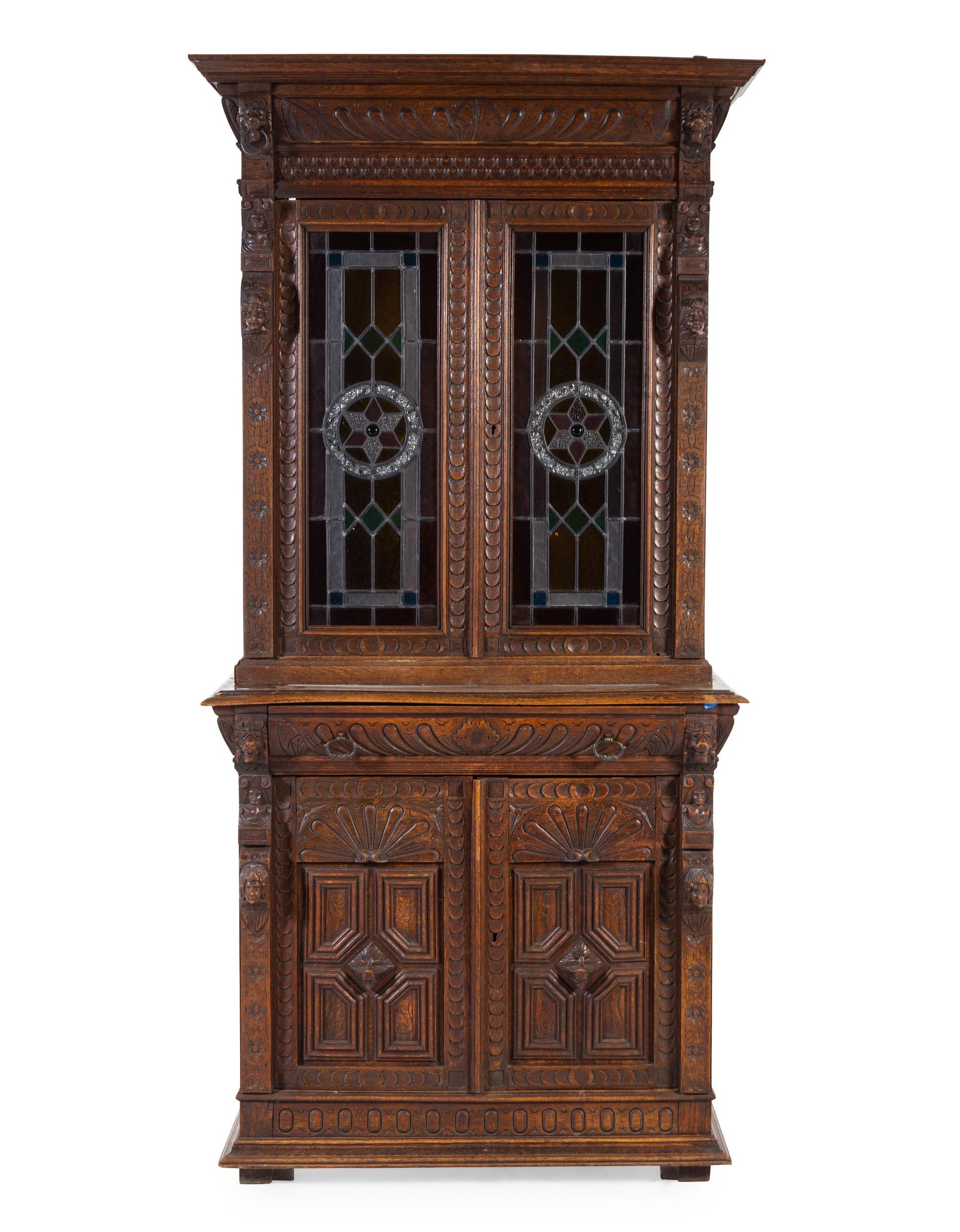 A Renaissance Revival Carved Oak and Leaded Glass Bookcase