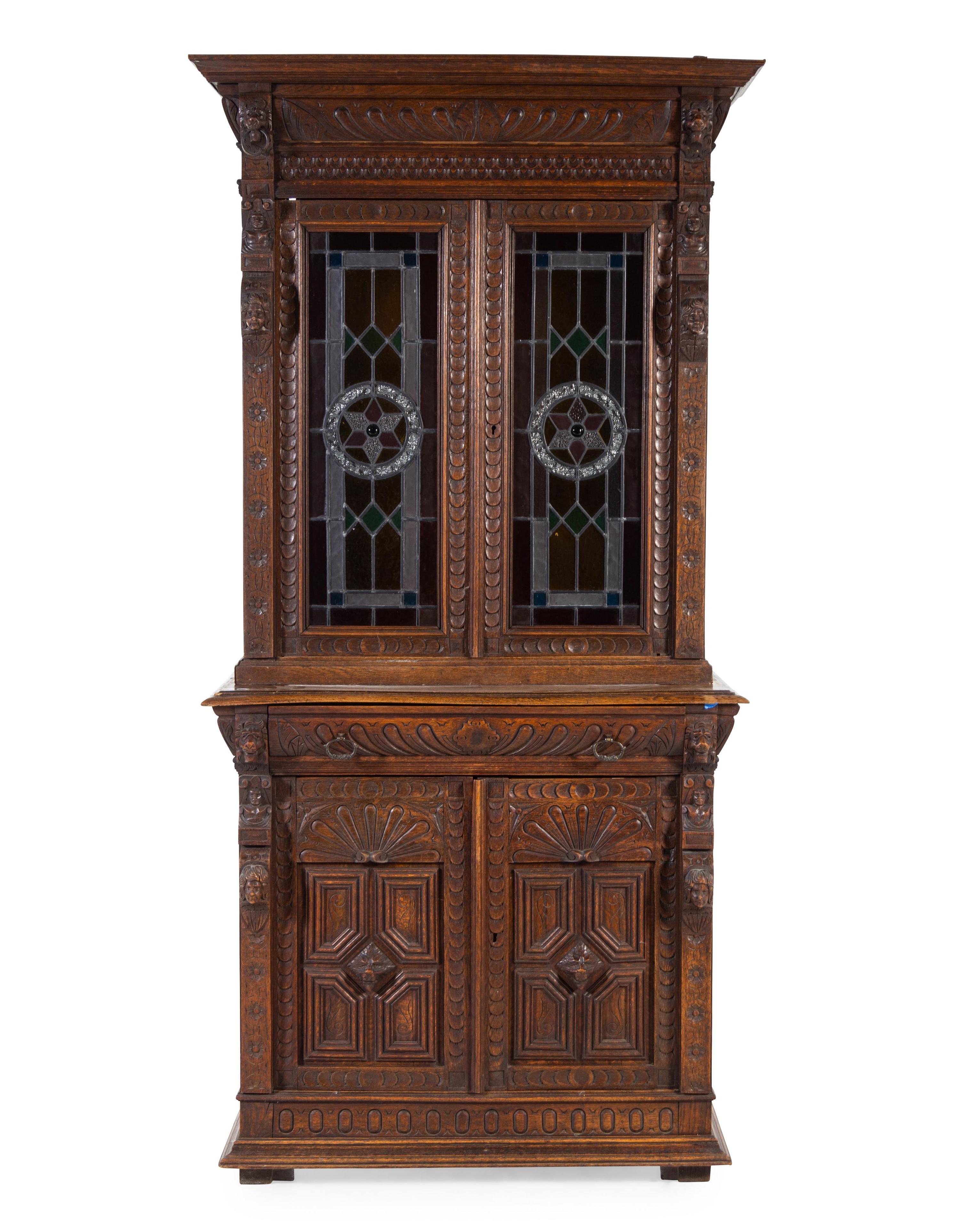 A Renaissance Revival Carved Oak and Leaded Glass Bookcase