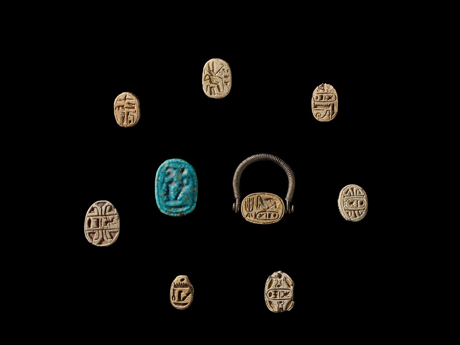Nine Egyptian Faience and Steatite Scarabs with Royal Inscriptions