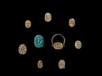 Nine Egyptian Faience and Steatite Scarabs with Royal Inscriptions