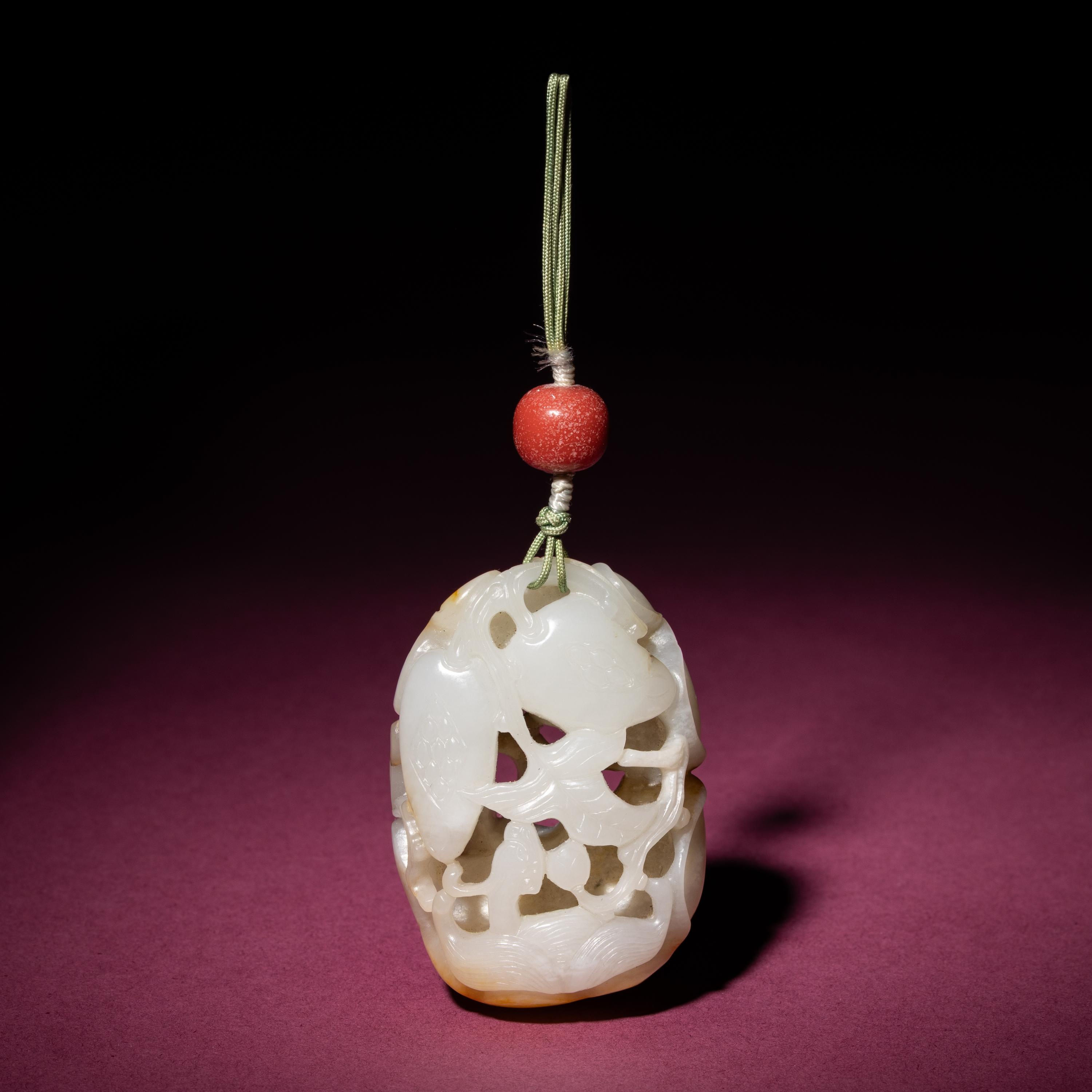 A Chinese Russet and White Jade Reticulated Pendant, 18th/19th Century — 清中期 白玉帶皮鏤雕石榴荔枝佩