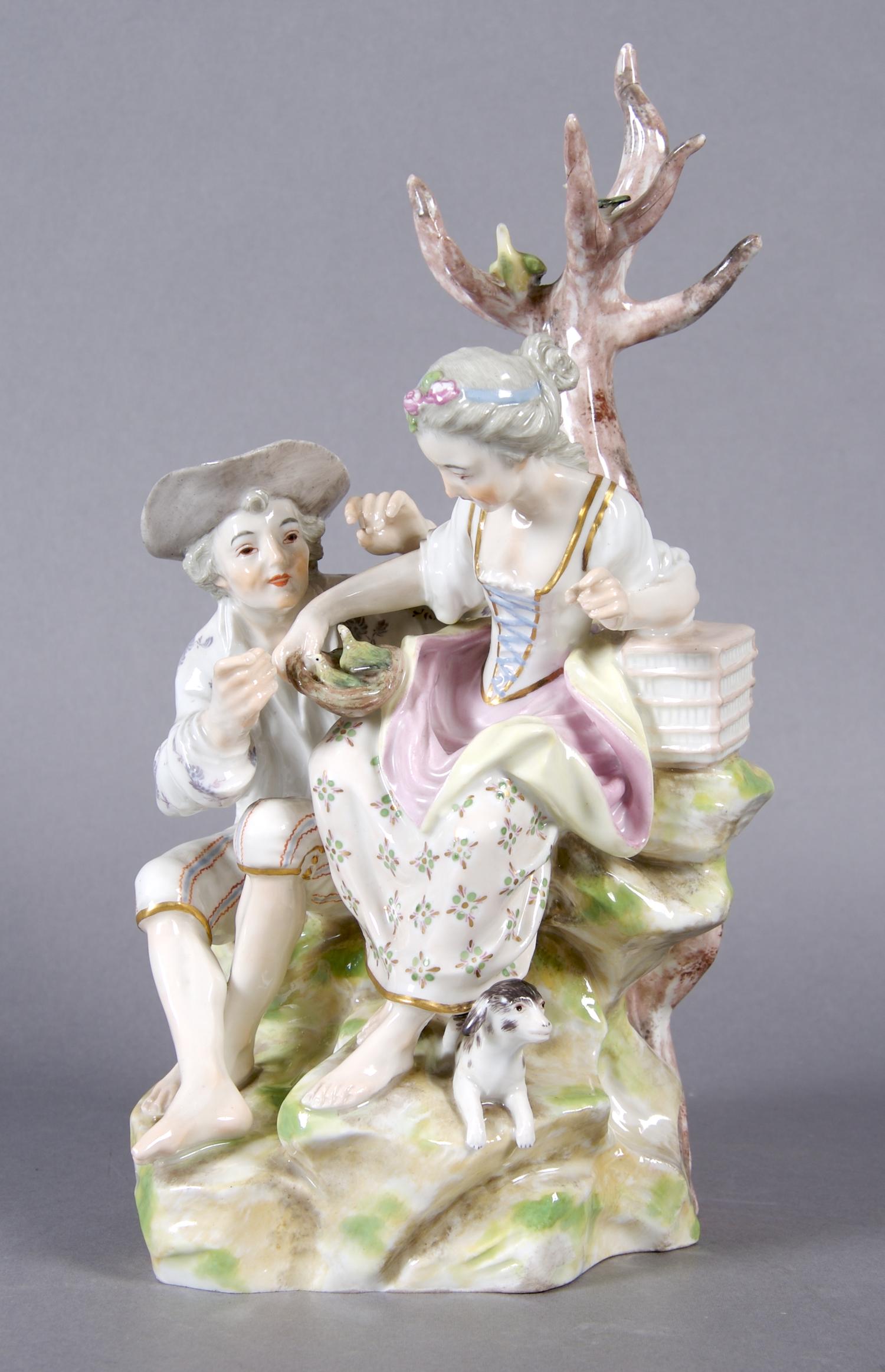A German Porcelain Figural Group, Height 10 inches.