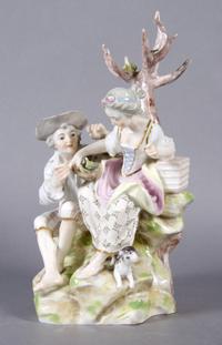 A German Porcelain Figural Group, Height 10 inches.