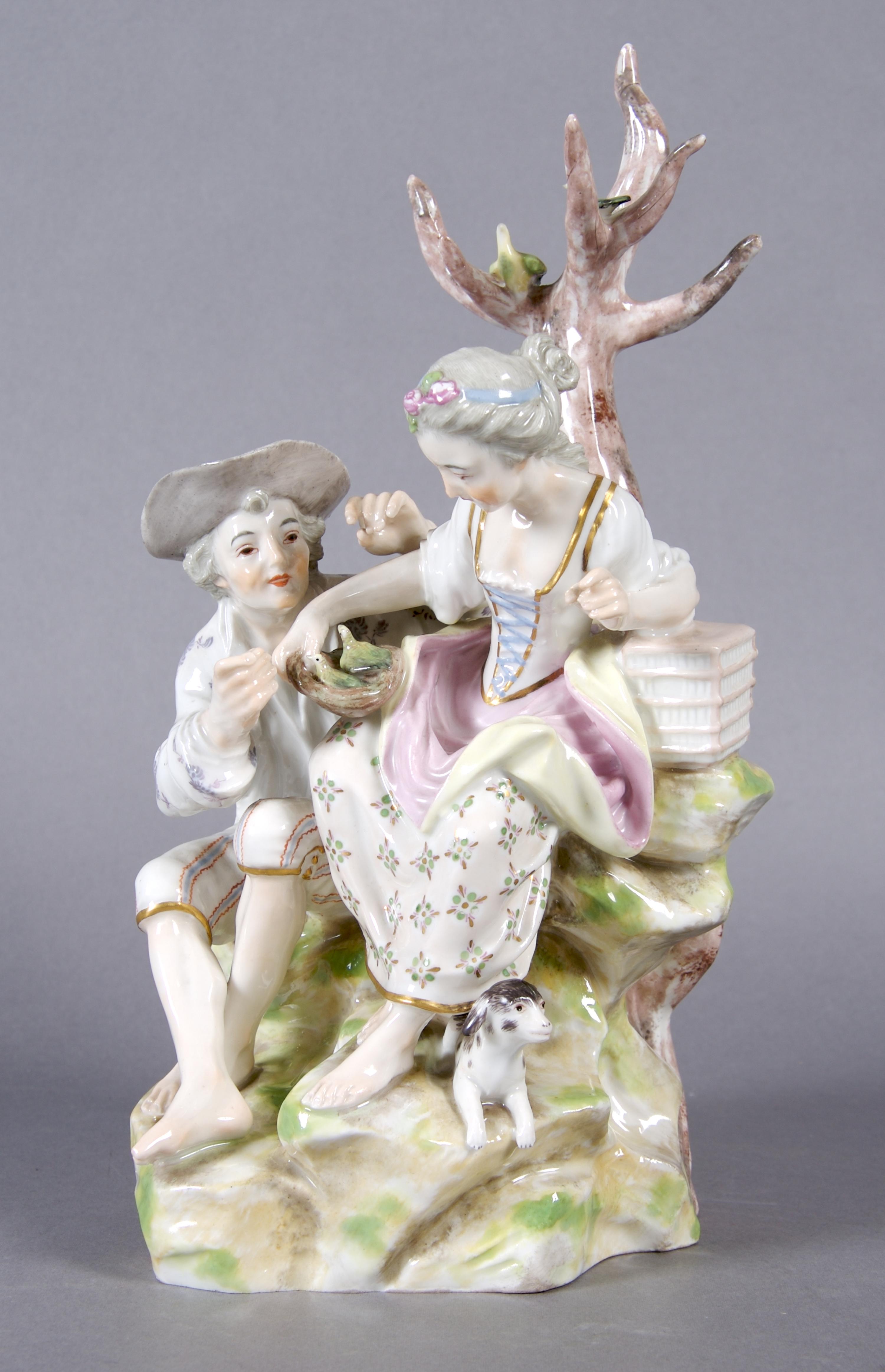 A German Porcelain Figural Group, Height 10 inches.
