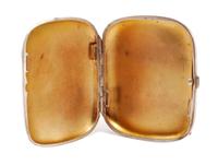 A German Enameled Silver Cigarette Case, Late 19th/Early 20th Century, the lid enameled to show a reclining nude, the underside with an