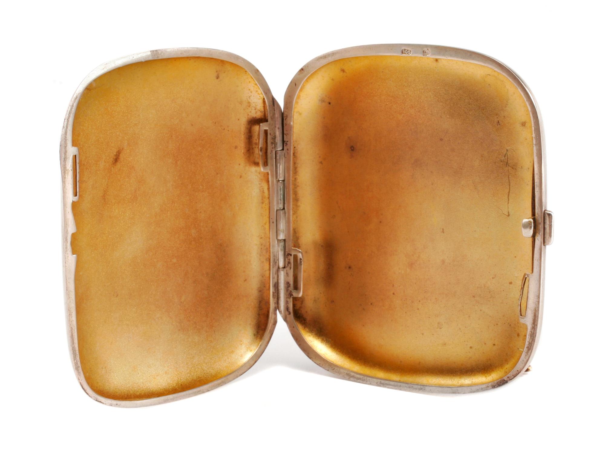 A German Enameled Silver Cigarette Case, Late 19th/Early 20th Century, the lid enameled to show a reclining nude, the underside with an