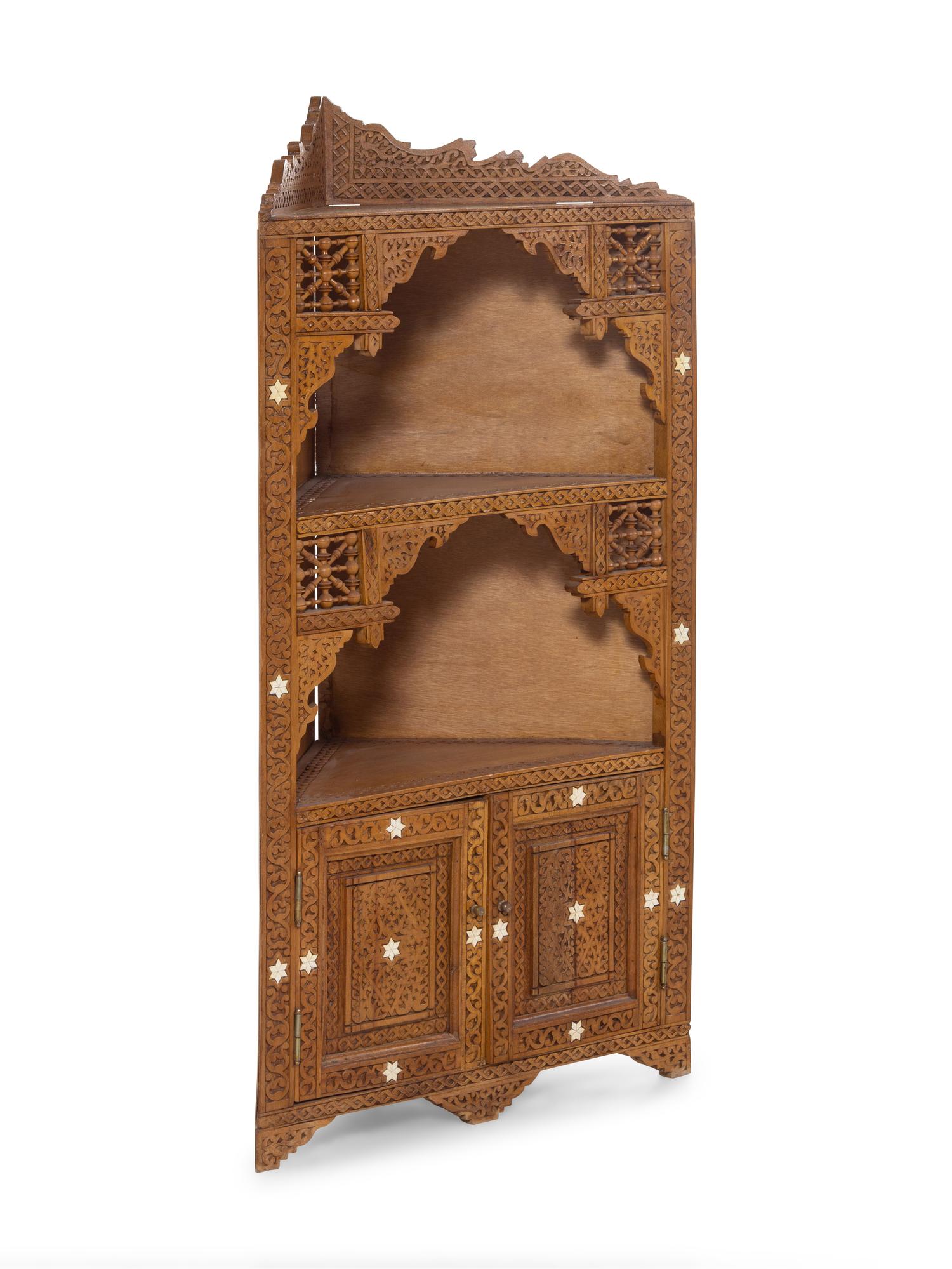 An Egyptian Carved and Inlaid Corner Cabinet