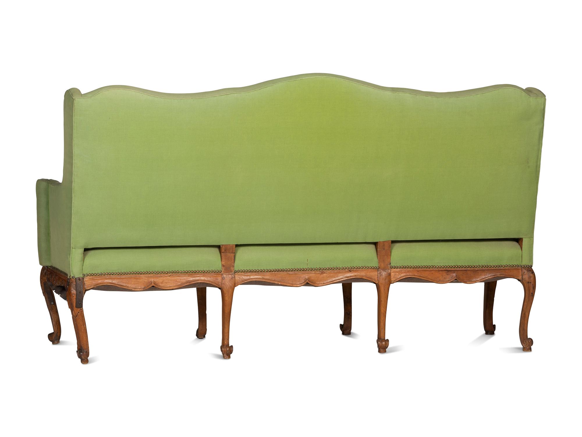 A French Provincial Carved Fruitwood Upholstered High-Back Sofa