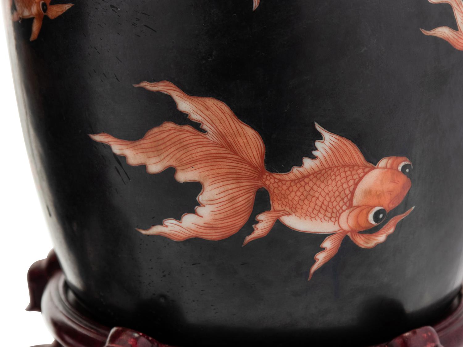 A Pair of Chinese Porcelain Goldfish Jars with Wood Stands