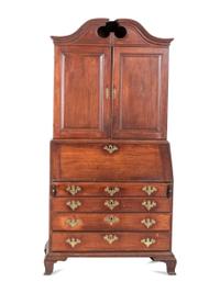 A Chippendale Carved and Paneled Mahogany Slant-Front Desk-and-Bookcase