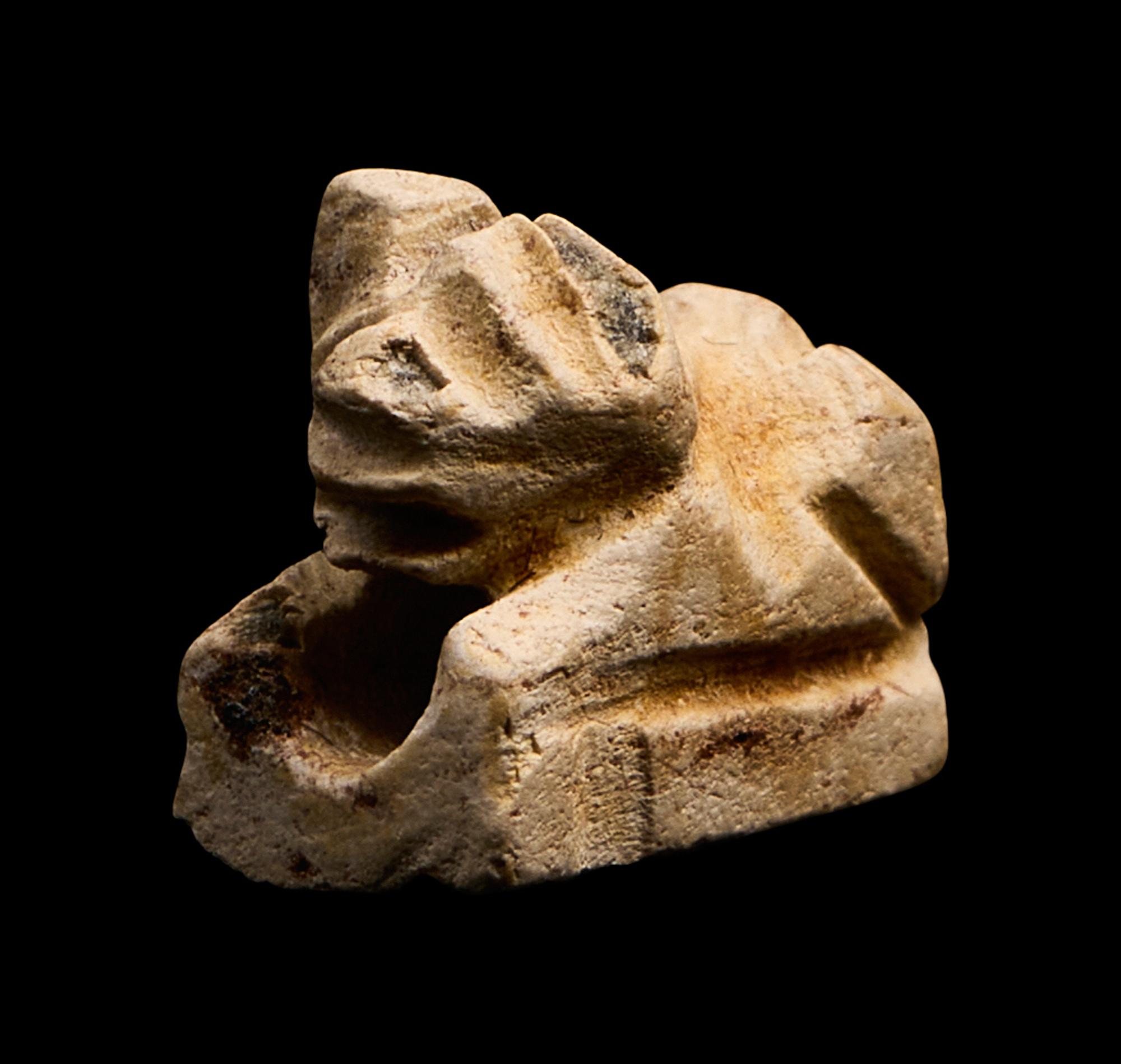 An Egyptian Faience Recumbent Bull or Ram