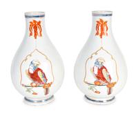 A Pair of Famille Rose Porcelain Parrot on a Perch Vases — AFTER A DESIGN BY CORNELIUS PRONK, 19TH CENTURY