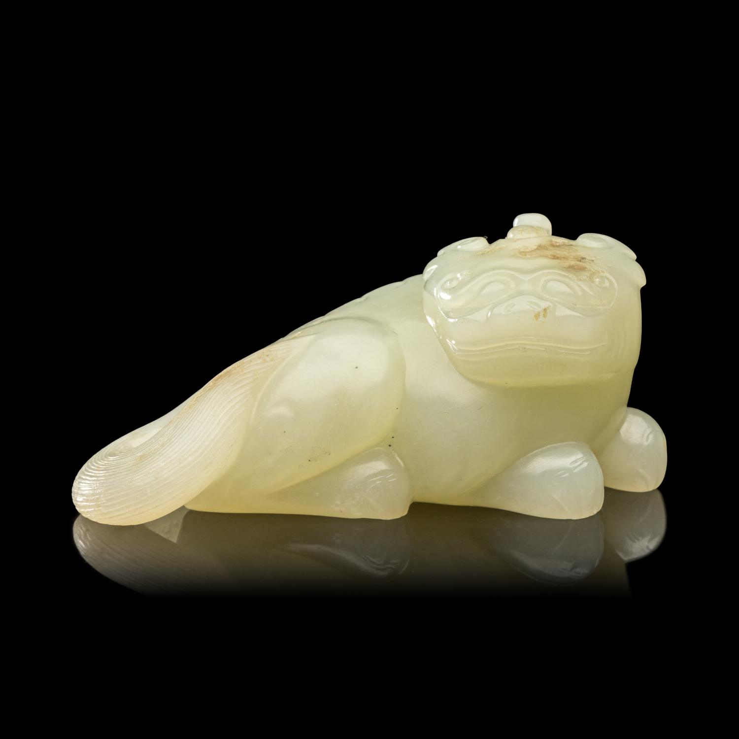 A Chinese Pale Celadon Jade Figure of a Mythical Beast, Early Qing Dynasty 清早期 青白玉瑞獸