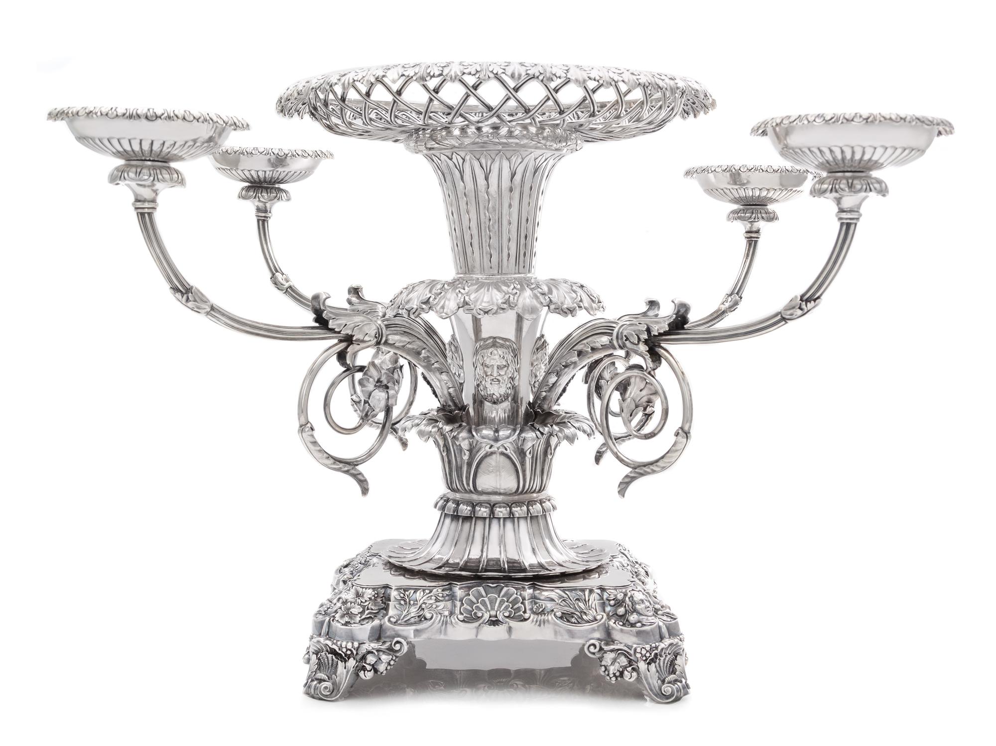 A George III Silver Epergne, Paul Storr, London, 1814, the foliate rim above an openwork basket and acanthus and mask decorated stem is