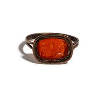 A Roman Carnelian Ring Stone with the God Eros Beside a Tropaion — Set in a gilt-copper ring