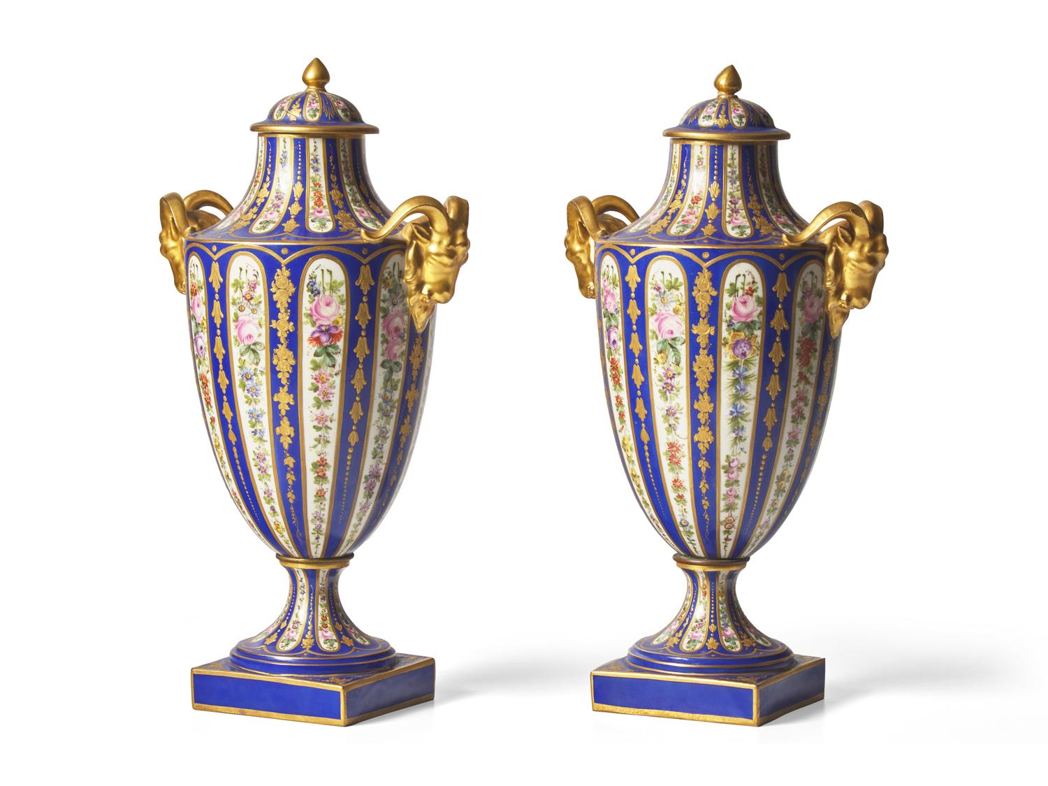 A Pair of Sevres Parcel Gilt, Cobalt and Garland Decorated Porcelain Lidded Urns