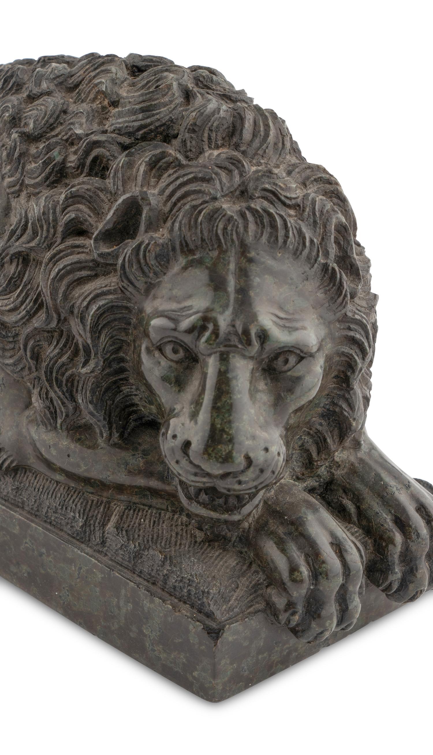 A Pair of Carved Green Marble Recumbent Lions