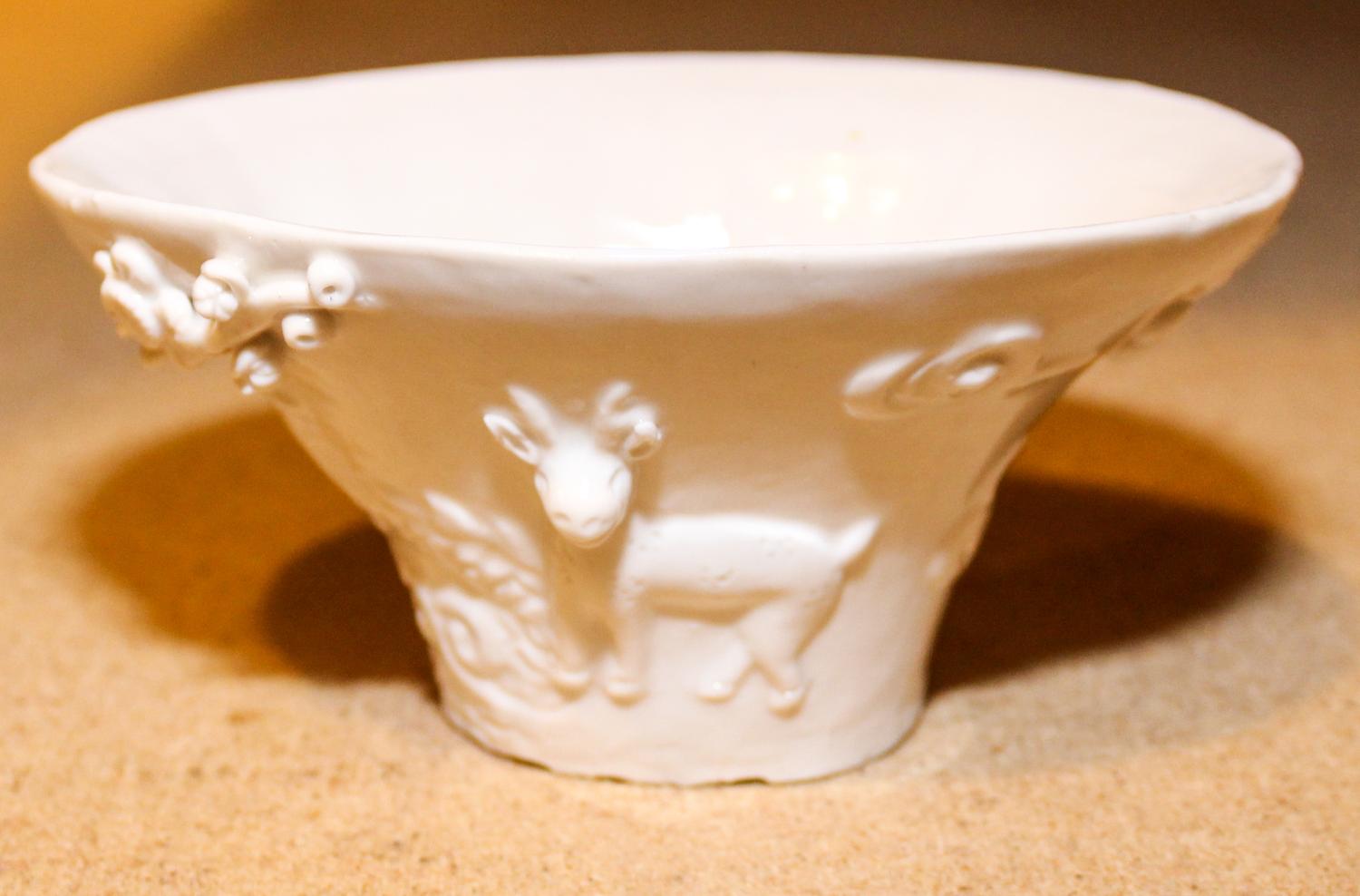 A Blanc de Chine Porcelain Cup. Length 5 3/8 inches.