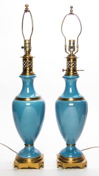 A Pair of Continental Gilt Metal Mounted Porcelain Table Lamps Height 30 3/8 inches. — 20TH CENTURY