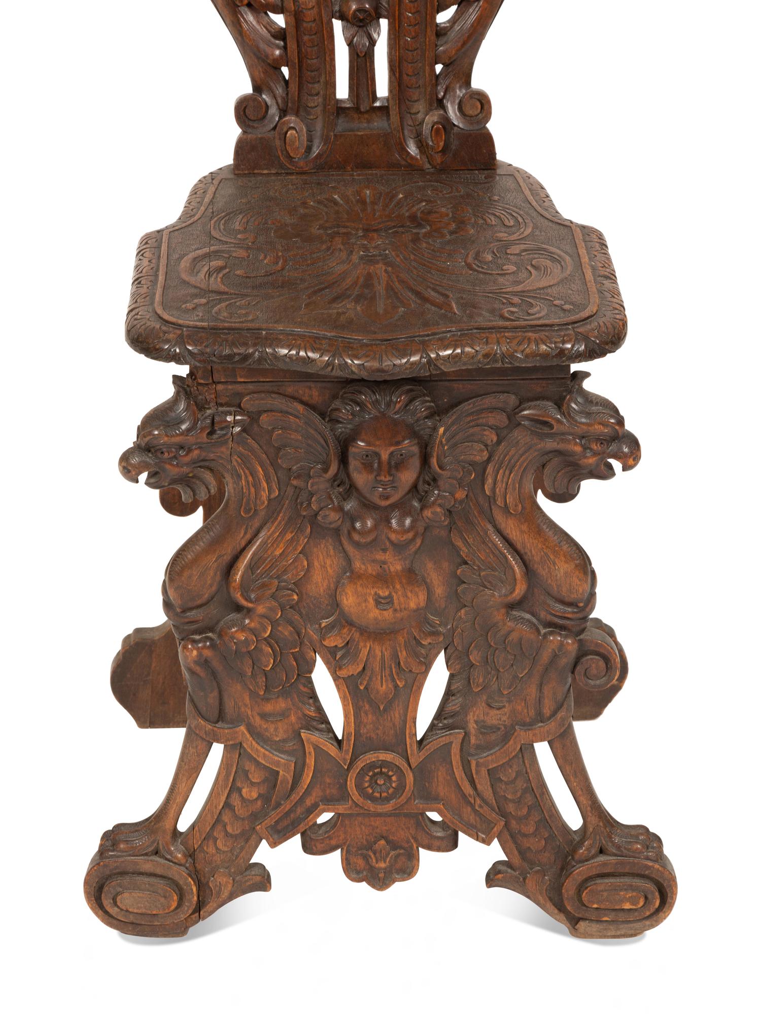 An Italian Renaissance Revival Carved Walnut Sgabello Hall Chair