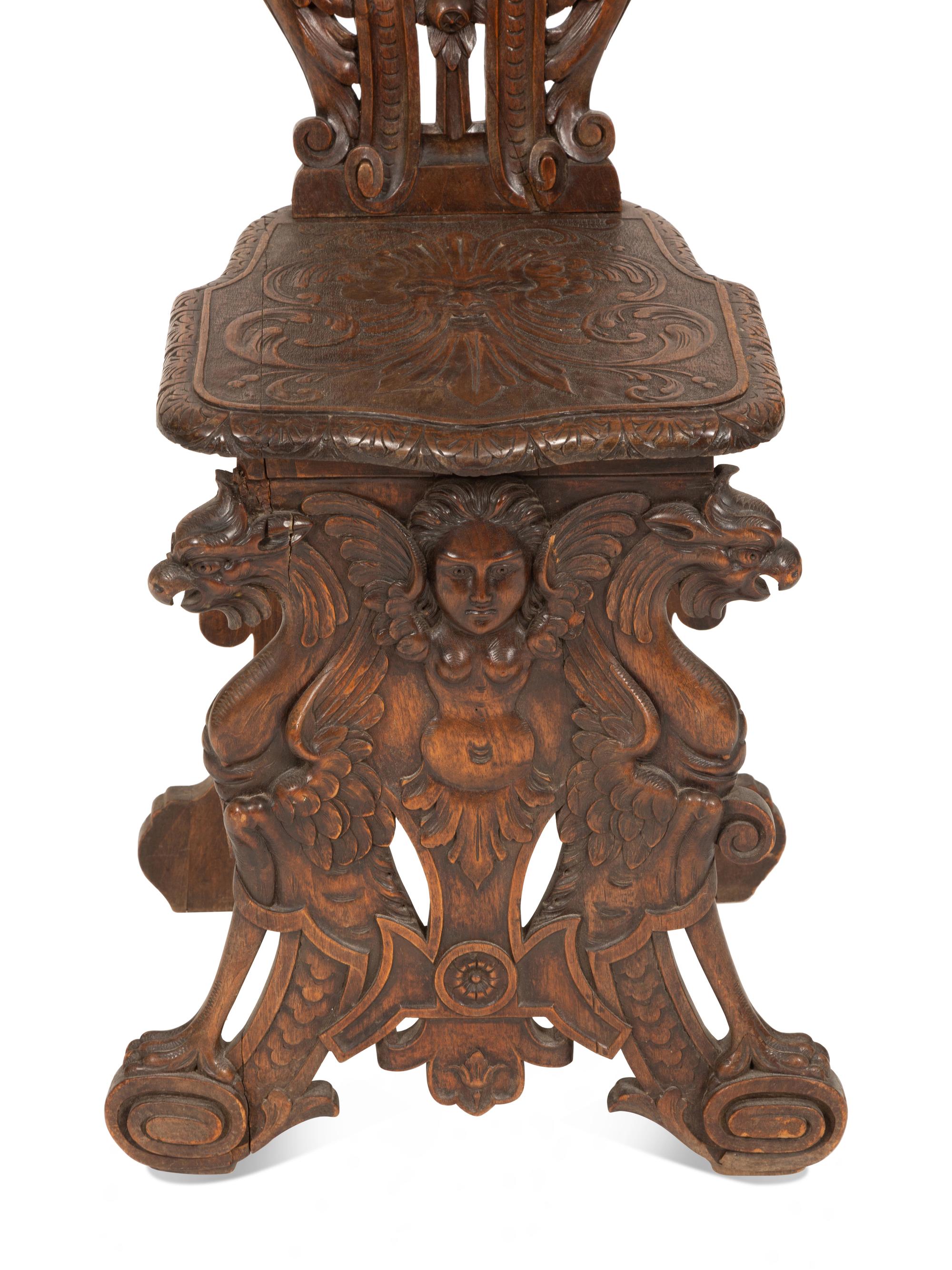 An Italian Renaissance Revival Carved Walnut Sgabello Hall Chair